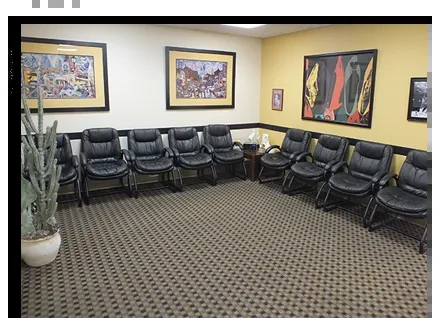 The comfortable waiting room at the Center for Foot and Ankle Disorders, with leather chairs and framed artwork